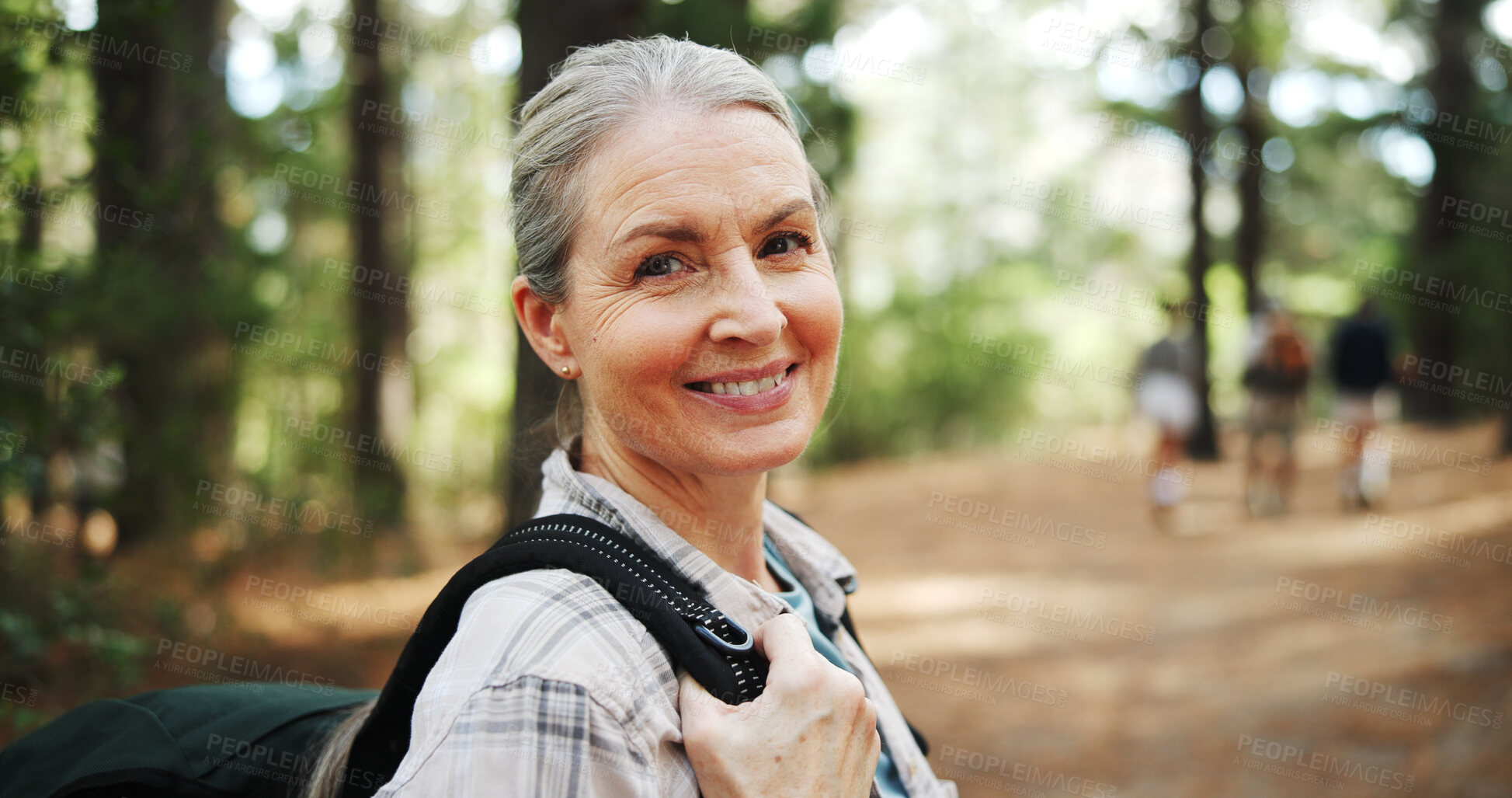 Buy stock photo Hiking, forest and portrait of mature woman in nature with backpack for exercise, walking and health. Fitness, travel and person in woods for trekking, adventure and journey outdoor for wellness