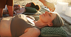 Woman, crystal and hands at beach with chakra balance, care and therapy with rest on vacation. People, awareness and shaman with stone on forehead with mineral, mindfulness or zen on ground in summer