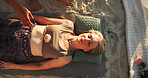 Woman, crystal and therapy at beach with chakra balance, energy and healing with rest on vacation. Person, stone and holistic care with mineral, mindfulness and shaman with zen on ground in summer