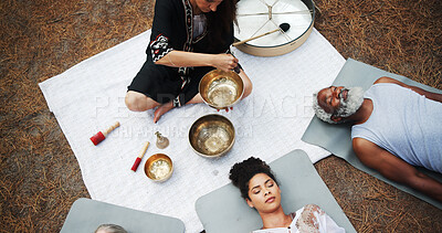 Buy stock photo Above, sound therapy and woman with bowls in park for mindfulness, spiritual cleanse and energy. Nature, meditation ritual and men and women with vibration for healing, balance and wellness by ocean