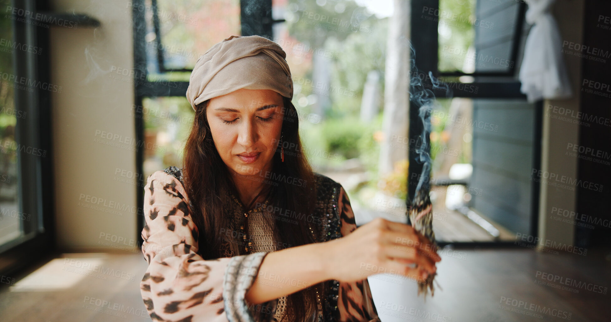 Buy stock photo Cleansing, woman and sage with smoke, smudging and burning herb for purification or indigenous tradition. Chakra, spiritual and person with Salvia apiana for prayer, morning or ritual for inner peace