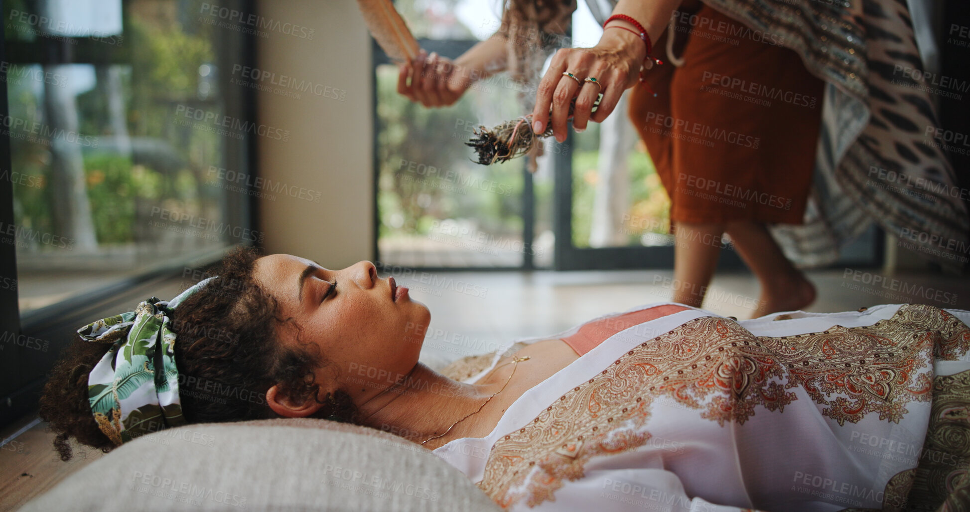 Buy stock photo Spiritual, healing and woman with shaman, hands and smudging for cleansing, traditional and inner peace. Holistic, sage and smoke for awakening of person, chakra and ritual to remove negative energy