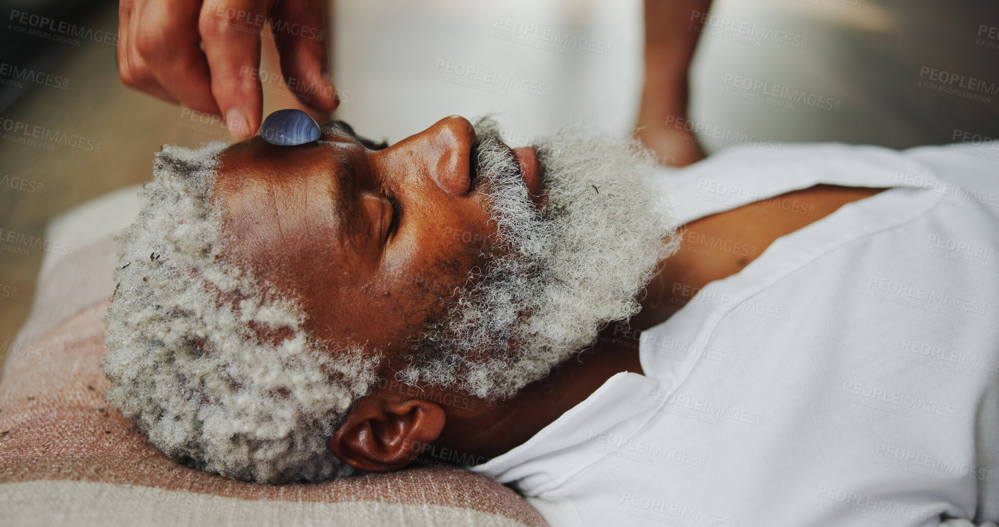 Buy stock photo Crystal, meditation and healing with man on floor for energy balance, zen ritual or spirituality. Third eye chakra, peace or holistic with senior person for aura cleanse, shaman and wellness ceremony