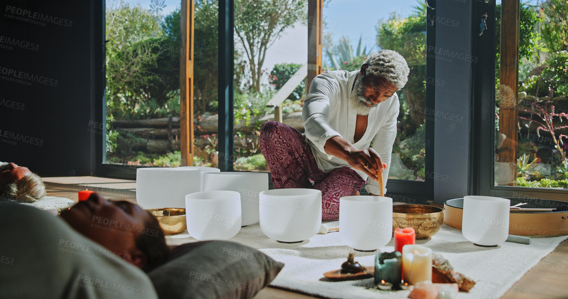 Buy stock photo Man, singing bowl and group on floor with sound, therapy or lying with mindfulness at studio. Person, shaman and guide for class with people, crystal or zen for chakra balance for holistic healing
