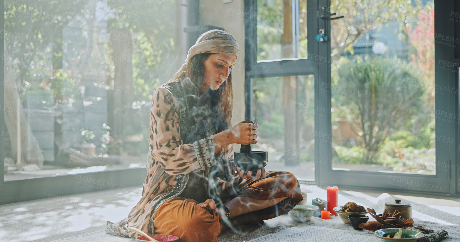 Buy stock photo Woman, alternative medicine and meditation with naturopath with sage smoke, ceremony and culture in studio. Female healer, herbs and aromatherapy for Buddhism with chakra clean or natural healing