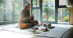 Woman, natural healing and meditation with naturopath for Buddhism, ceremony and culture in studio. Healer, grinding herbs and aromatherapy for spirituality with incense or alternative medicine