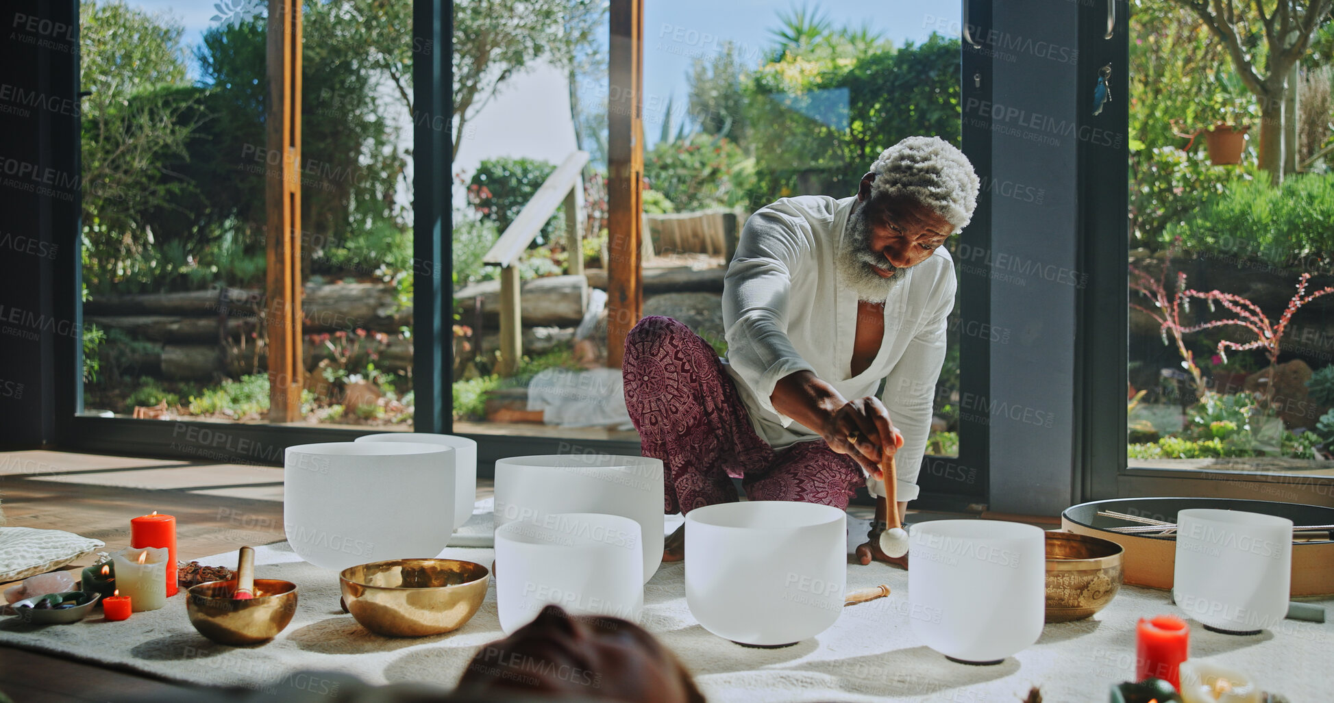 Buy stock photo Man, singing bowl and floor for holistic therapy, frequency and peace with mindfulness at studio. People, shaman and healing with guide in class, crystal or zen for chakra balance at wellness resort