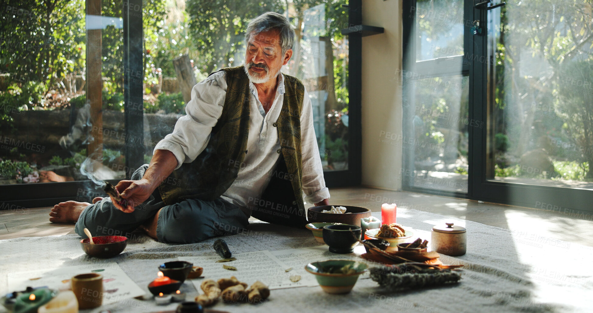 Buy stock photo Crystal, alternative medicine and Asian man for spiritual meditation, holistic treatment and healing on floor. Aromatherapy, incense and healer with stones for peace, chakra and detox for wellness