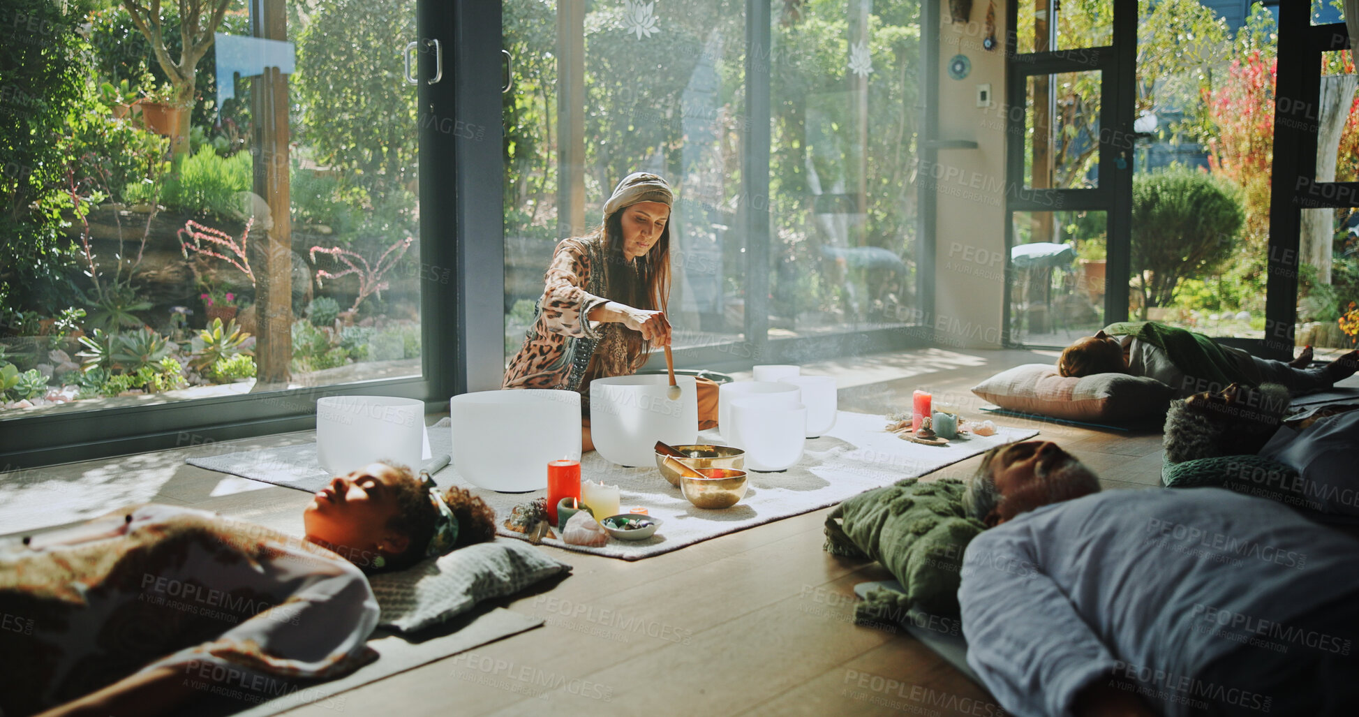 Buy stock photo Woman, singing bowl and healing on floor for therapy, frequency and peace with mindfulness at studio. Group, shaman and holistic with guide in class, crystal and zen for chakra balance at resort