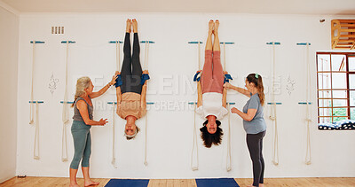 Buy stock photo Stretching, upside down and rope on wall for yoga for senior group or people practice iyengar together in gym class. Women, body health and friends help for wellness, exercise and flexibility at club