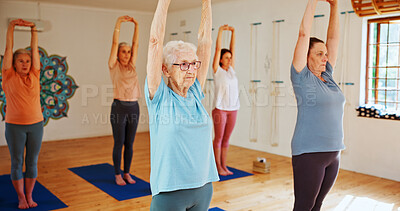 Buy stock photo Senior women, stretching and yoga class with group for holistic health, balance or wellness. Elderly, female people or yogi with arms up in pilates for workout, exercise or fitness together in studio
