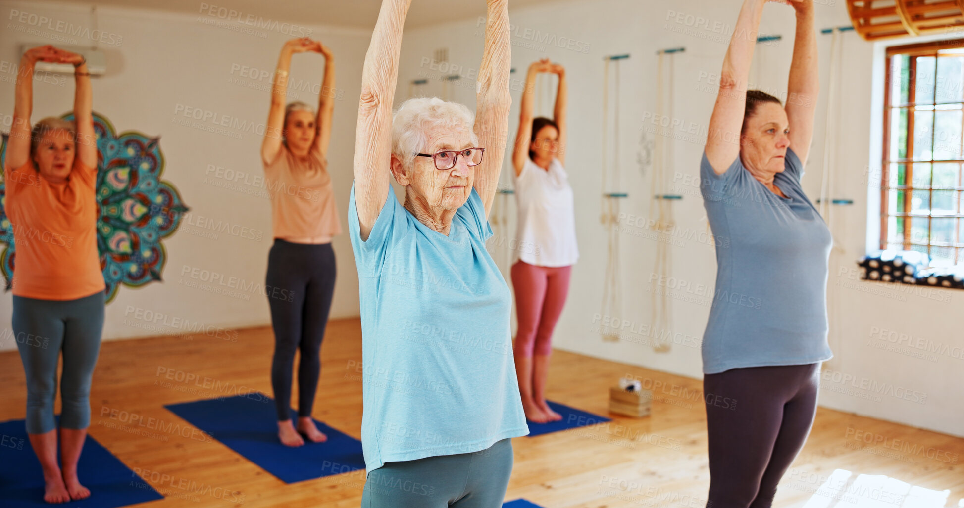 Buy stock photo Senior women, stretching and yoga class with group for holistic health, balance or wellness. Elderly, female people or yogi with arms up in pilates for workout, exercise or fitness together in studio