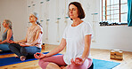 Floor, lotus and women with meditation class for calm mindset, zen or peace in mental wellness. Posture, morning and mature people in group yoga together for mindfulness, relax or holistic self care