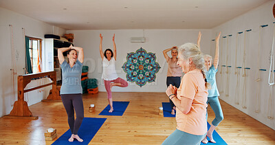 Buy stock photo Yoga class, senior women and fitness with instructor, spiritual wellness and pilates with energy. Elderly people, trainer and group in health club, help and coach with exercise, balance or stretching