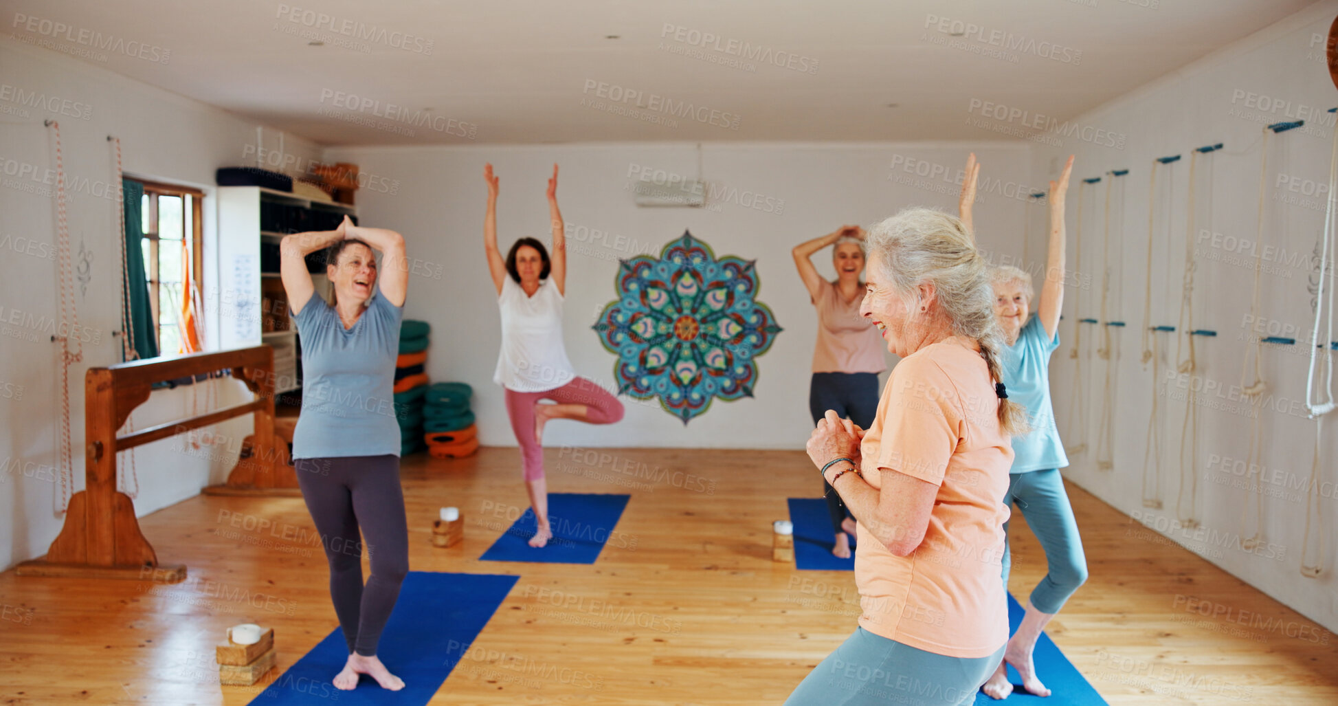 Buy stock photo Yoga class, senior women and fitness with instructor, spiritual wellness and pilates with energy. Elderly people, trainer and group in health club, help and coach with exercise, balance or stretching