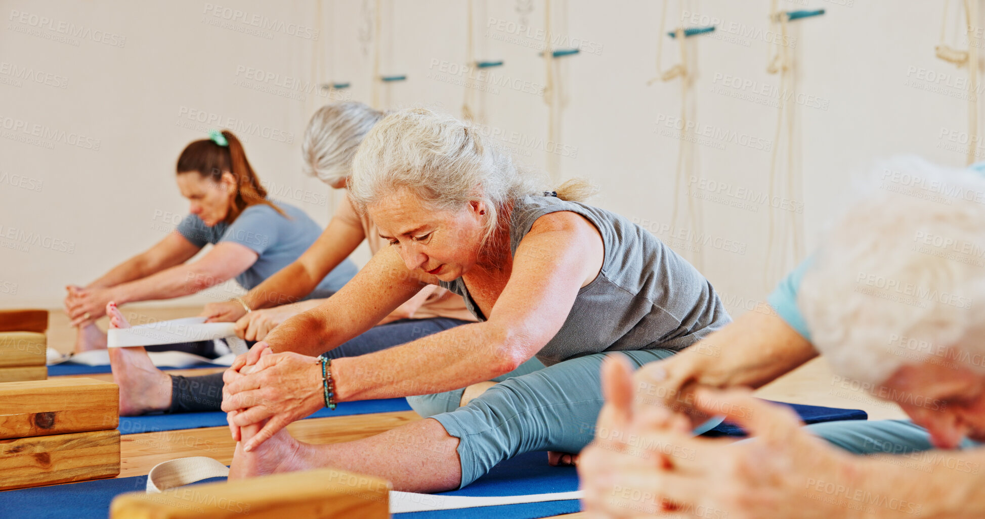 Buy stock photo Elderly woman, stretching and legs in yoga class, flexibility and spiritual wellness. Senior person, muscle warm up and community for pilates, holistic practice and mobility exercise at health club