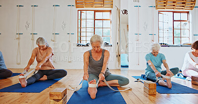 Buy stock photo Senior, people and stretching with band for yoga class, flexibility and spiritual wellness. Elderly women, muscle warm up and community pilates, holistic practice and mobility exercise at health club