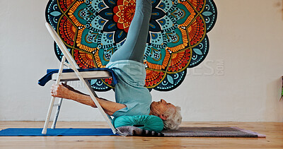 Buy stock photo Exercise, upside down or yoga and woman in studio with wall art for fitness or wellness routine. Balance, pilates or profile and senior person in class with mandala symbol for holistic health