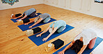 Group, senior and people stretching in yoga class for fitness, exercise and spiritual wellness. Elderly women, warm up and downward dog pose for pilates, community and holistic balance at health club