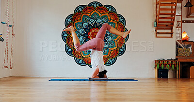 Buy stock photo Balance, upside down or yoga and woman in class with wall art for fitness or wellness routine. Exercise, headstand or pilates and yogi person in studio with mandala symbol for holistic health