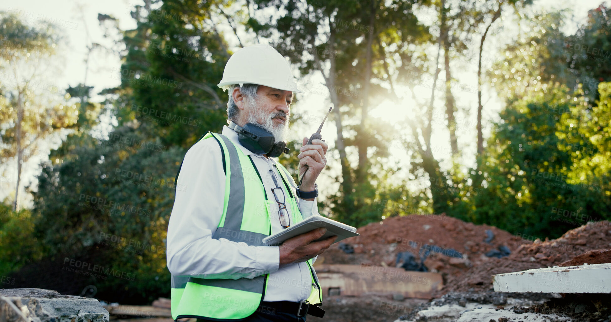 Buy stock photo Architecture, radio and tablet with construction worker man on site for communication, development or planning. Building, earmuffs and hardhat with developer person outdoor for industrial engineering