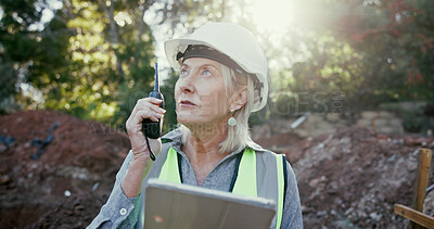 Buy stock photo Building, radio and tablet with construction worker woman on excavation site for development or planning. Architecture, communication and thinking with mature developer outdoor for engineering