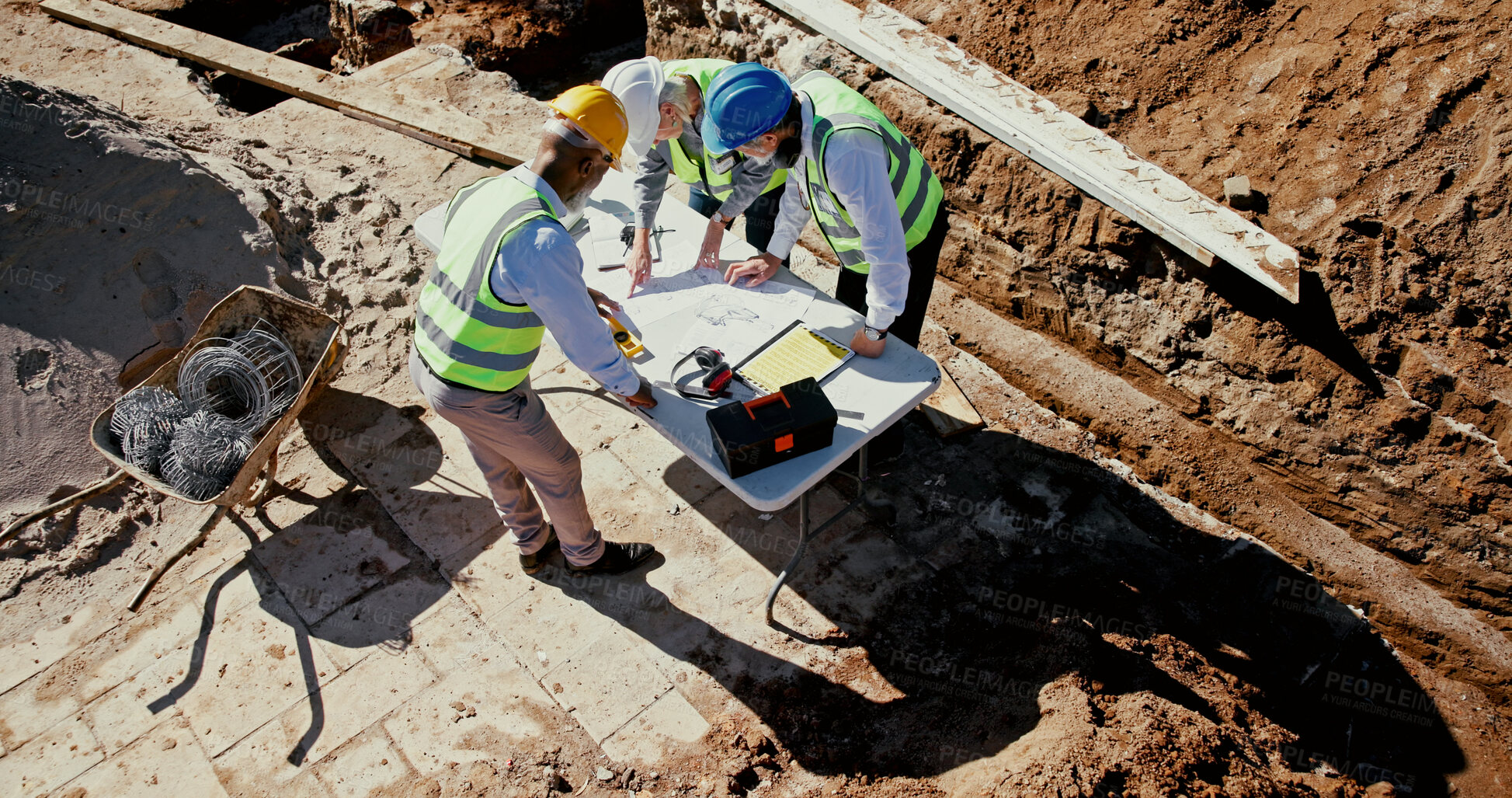 Buy stock photo Above, blueprint and team on construction site for planning, check design and engineering collaboration. Architect people, building layout and outdoor in meeting for brainstorming, compliance or PPE