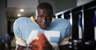 Buy stock photo Black man, football player or portrait in locker room with ball, intensity or ready for tournament. National sport, serious or athlete in cloakroom for fitness, game preparation or competition in USA