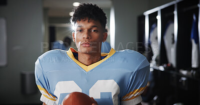 Buy stock photo Man, football player and ball in locker room for portrait, protective gear and confident for tournament. National sport, serious and athlete in cloakroom for fitness, game and competition in USA