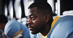 Thinking, black man and football player for sports in locker room for match, strategy and game plan. Male athlete, waiting and half time with competition ideas, fitness challenge and tournament event