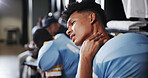 Man, American football player and neck pain with stress in locker room, frustrated or sprain with sport injury. Person, muscle ache and athlete with strain, bruise or massage for inflammation at club