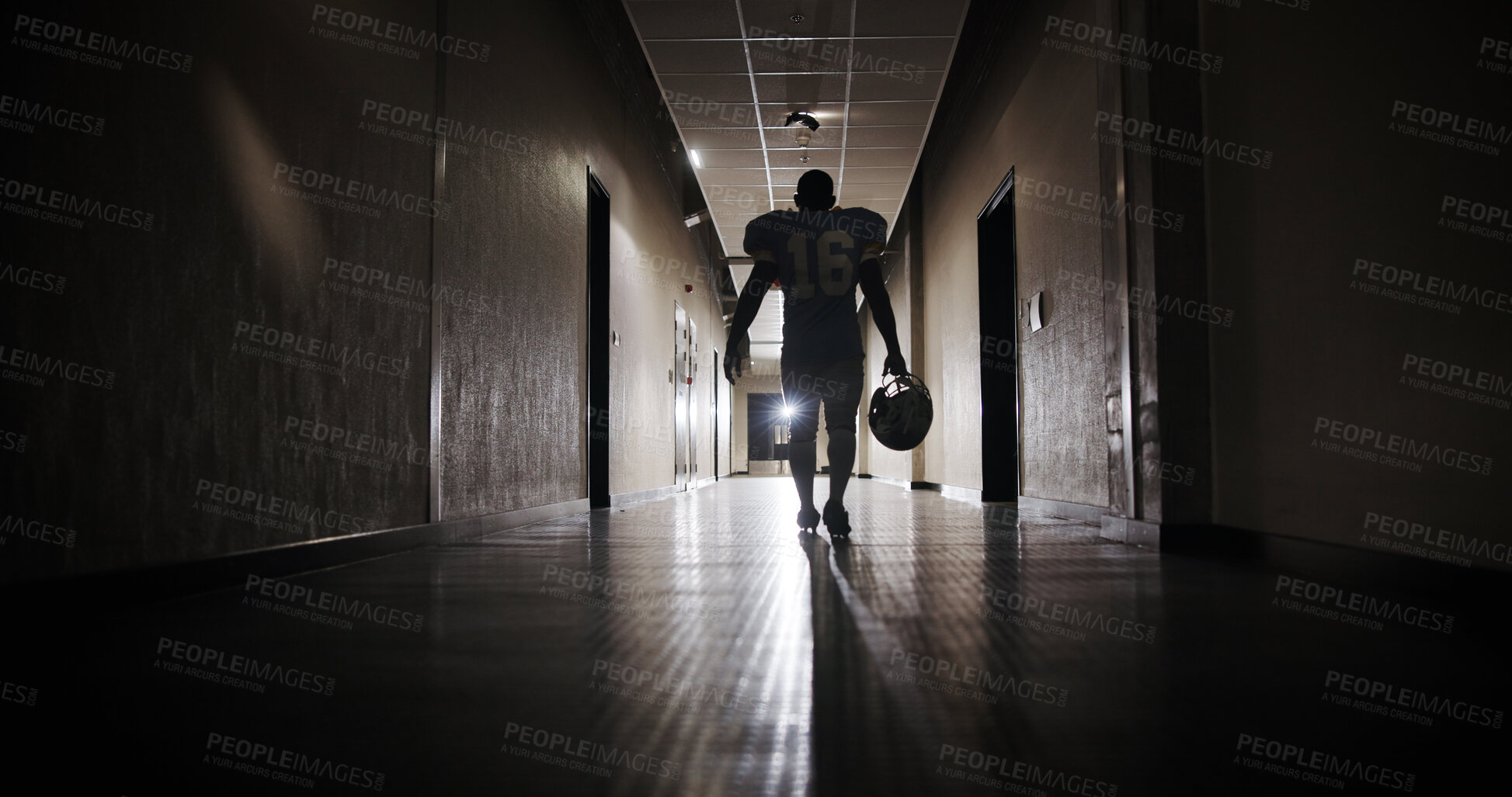 Buy stock photo Back, football and light with man in corridor for sports competition, stadium match and game. Fitness, pro league player and athlete with person in tunnel for training, tournament and contest