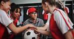 Women, coach and hands together with soccer ball for teamwork, motivation or collaboration in locker room. Female people, group or sport players piling with stack in huddle for game plan or match