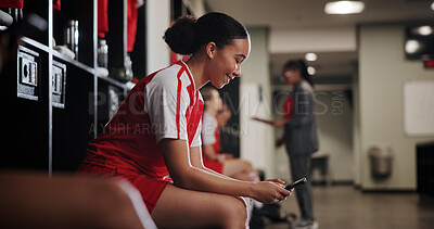 Buy stock photo Phone, woman and athlete in locker room for game, match or practice with scrolling on social media. Happy, relax and female soccer player with cellphone for networking on mobile app in changing area.
