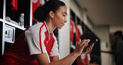 Buy stock photo Phone, woman and athlete in locker room for training, match or game with scrolling on social media. Happy, relax and female soccer player with cellphone for networking on mobile app in changing area.
