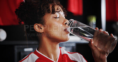 Buy stock photo Girl, soccer player and drinking water with bottle in locker room for hydration, break or half time. Female person, athlete or thirst with refreshing mineral liquid for natural sustainability or rest