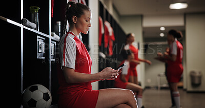 Buy stock photo Sports, football and woman with phone in locker room for social media, contact and communication. Athlete, soccer player and person typing on smartphone for match, training and tournament schedule