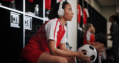 Buy stock photo Sports, locker room and woman with headphones and ball for music, audio and radio for tournament. Thinking, soccer and person for planning, reflection and thoughtful for match, game and practice