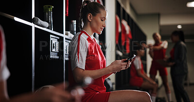 Buy stock photo Cellphone, woman and athlete in locker room for game, match or practice with scrolling on social media. Tech, relax and female soccer player with phone for networking on mobile app in changing area.