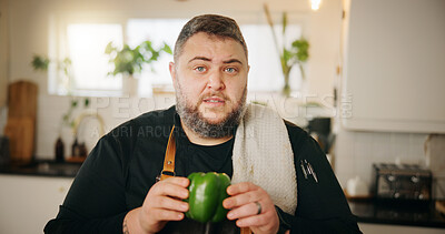Buy stock photo Cooking, portrait and man in kitchen, green pepper and influencer with ingredients, tutorial and live streaming. Face, person or chef with recipe, home or filming with video broadcasting or explain
