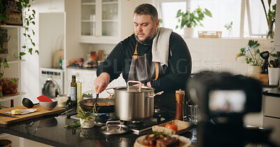 Buy stock photo Home, cooking and man with live streaming in kitchen for dinner tutorial, food vlog and video recording. Culinary influencer, content creation and person with cuisine instructions or meal preparation