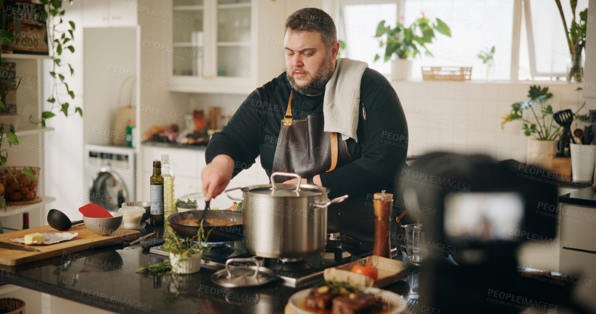 Buy stock photo Home, cooking and man with live streaming in kitchen for dinner tutorial, food vlog and video recording. Culinary influencer, content creation and person with cuisine instructions or meal preparation