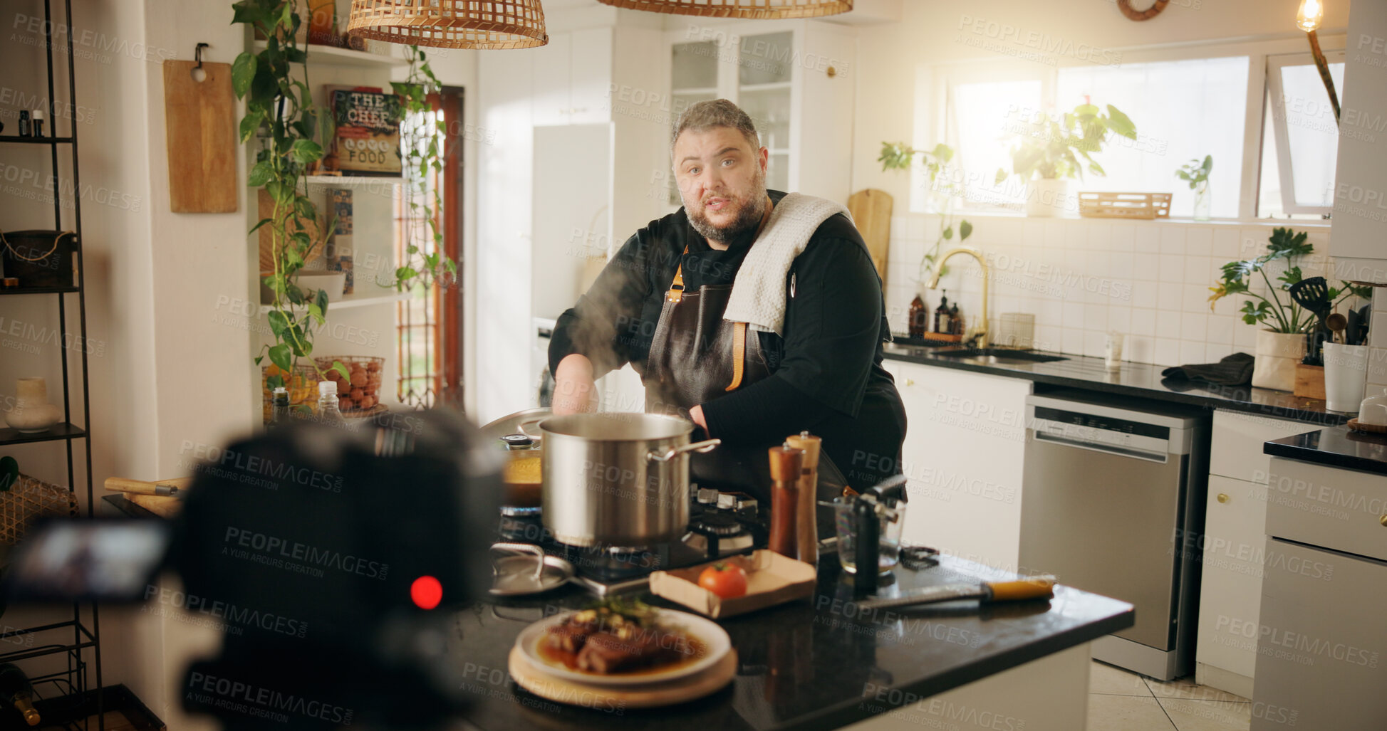 Buy stock photo Food, cooking and man with live streaming in kitchen for recipe tutorial, meal prep and video recording. Culinary influencer, content creation or person with cuisine instructions or nutrition in home