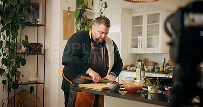 Buy stock photo Vegetables, cooking and man with live streaming in kitchen for dinner tutorial, meal prep or cut ingredients in home. Culinary influencer, person or cuisine vlog for content creation and online guide