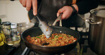 Person, hands and cooking with stove for food, meal prep or hospitality in kitchen at home. Closeup, culinary artist or mixing ingredients with pan for recipe, nutrition or dinner cuisine at house