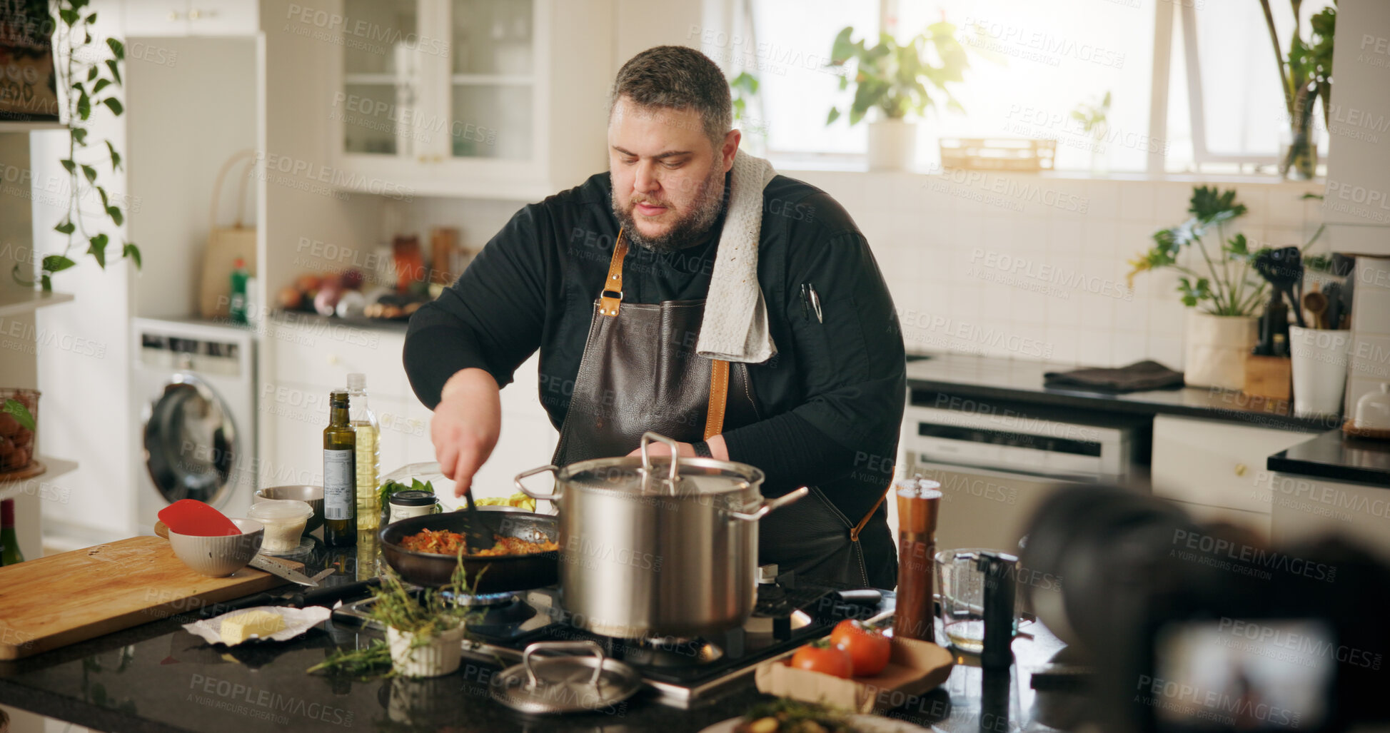 Buy stock photo Class, cooking and man with live streaming in kitchen for online tutorial, dinner meal and recipe recording. Culinary influencer, content creation and person with cuisine preparation and vlog in home