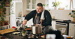 Food, cooking and man with live streaming in home for gourmet recipe tutorial, meal prep and recording. Content creator, chef and filming video with dinner instructions and nutrition tips in kitchen