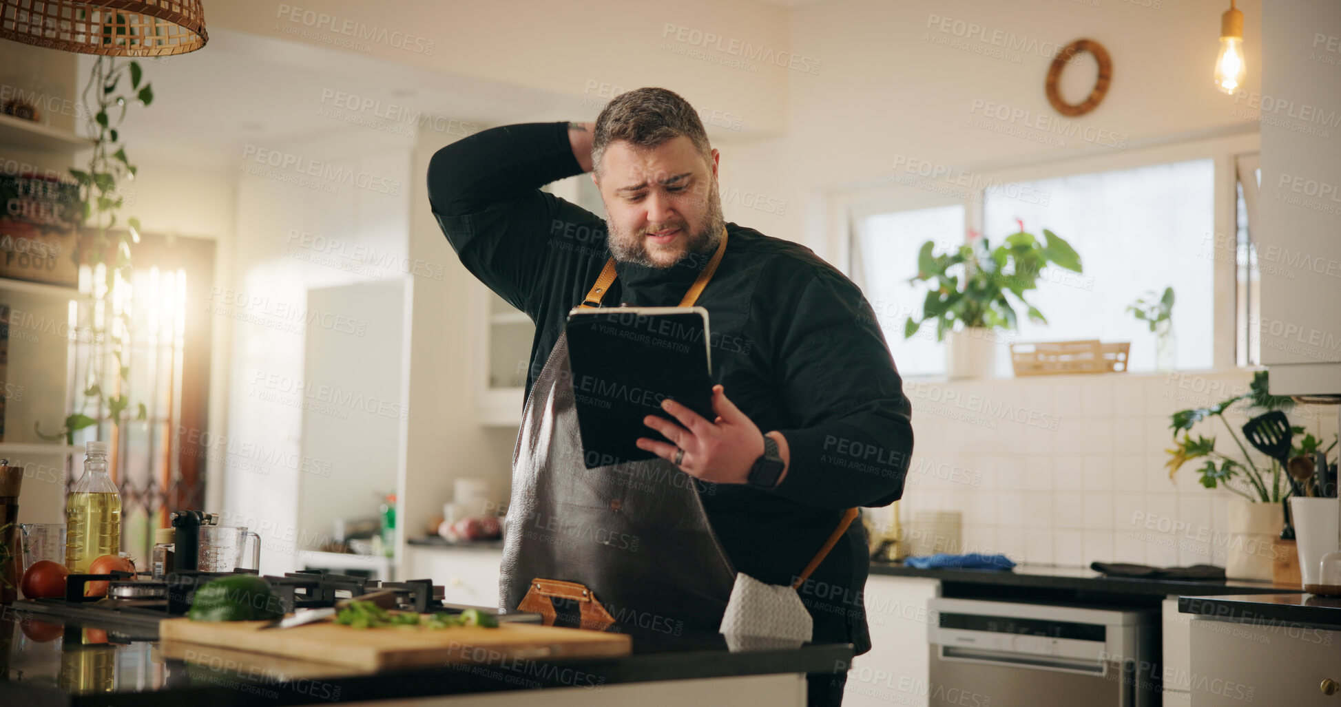 Buy stock photo Cooking, tablet and man in kitchen, stress and confused with glitch, mistake and cancelled order. Person, cuisine expert and chef with tech, anxiety and app for recipe, ingredients and doubt at home