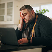 Man, chef and laptop with stress in kitchen for bad mistake, fatigue or ...