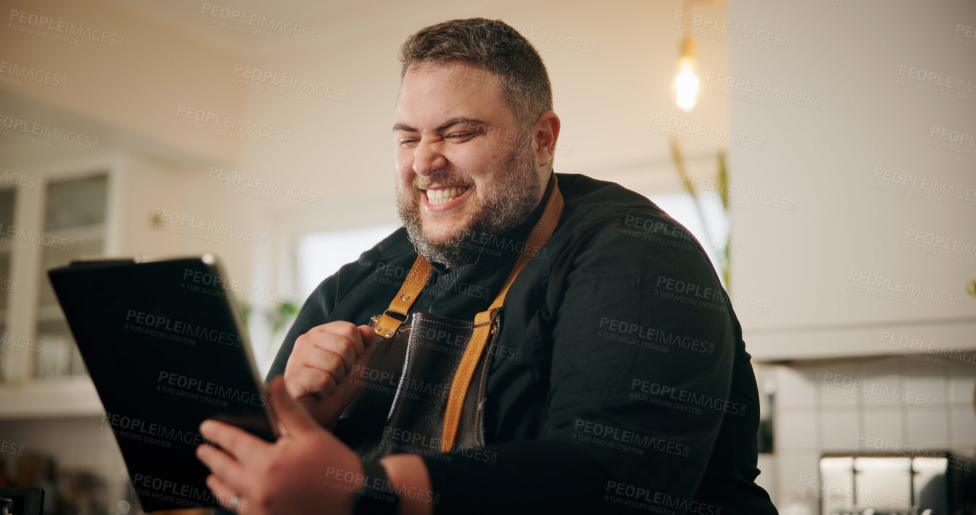 Buy stock photo Tablet, fist pump and chef in kitchen for online recipe planning or research for cook book with winning. Excited, technology and person read positive culinary review on restaurant business in home.